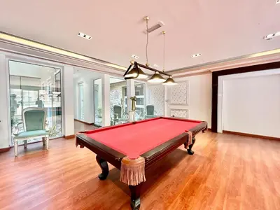 a pool table in a living room with avertisementatronatronatronstrationstrationstration at Homes2Retreat - Resort Living Close to Miracle Garden in Dubai