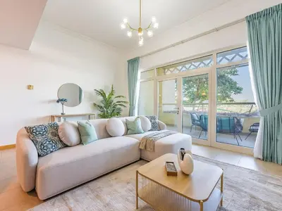 a living room with a couch and a table at Beachfront Sea View 1BR-Jash Falqa- Palm Jumeirah in Dubai