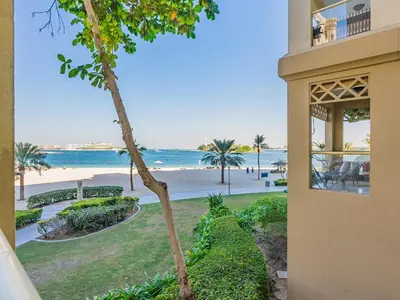 a view of the beach from the balcony of a house at Beachfront Sea View 1BR-Jash Falqa- Palm Jumeirah in Dubai