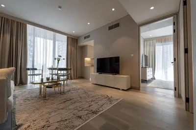 a living room with a television and a dining room at Gracious 1BR in Condor Marina Star, Dubai Marina in Dubai