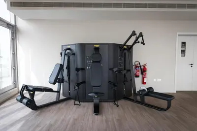 a gym with several treadmills and machines at Gracious 1BR in Condor Marina Star, Dubai Marina in Dubai