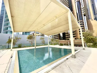 a swimming pool with a pavilion on top of a building at Iris Blue, Dubai Marina - Mint Stay in Dubai