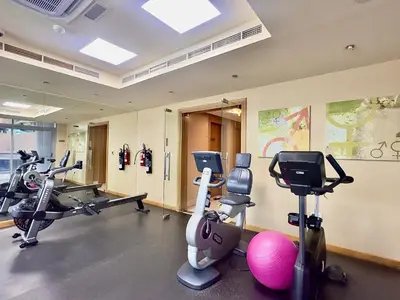 a gym with tread machines and exercise bikes in a room at Iris Blue, Dubai Marina - Mint Stay in Dubai