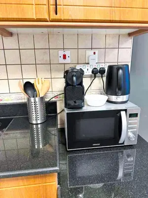 a kitchen counter with a microwave on top of it at Luxury 2-bedroom in Dubai Marina with Sea View in Dubai