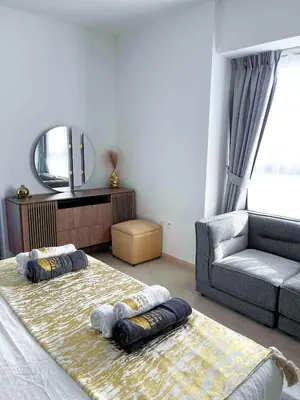 a room with a bed and a couch and a mirror at Luxury 2-bedroom in Dubai Marina with Sea View in Dubai