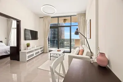 a bedroom with a bed and a desk with a chair at C&L Homes Dubai Canal in Dubai