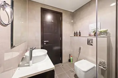 a bathroom with a toilet and a sink and a shower at C&L Homes Dubai Canal in Dubai