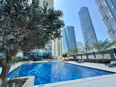 a swimming pool in a city with tall buildings at C&L Homes Dubai Canal in Dubai