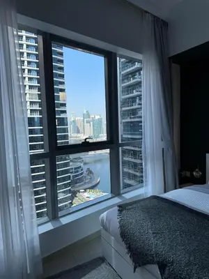 a bedroom with a large window with a view of the city at Modern Studio in Dubai Marina, JBR in Dubai
