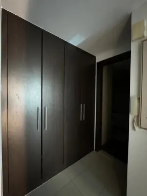 a room with wooden cabinets and a closet at Modern Studio in Dubai Marina, JBR in Dubai