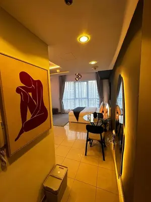 a living room with a couch and a dining room at Modern Studio in Dubai Marina, JBR in Dubai