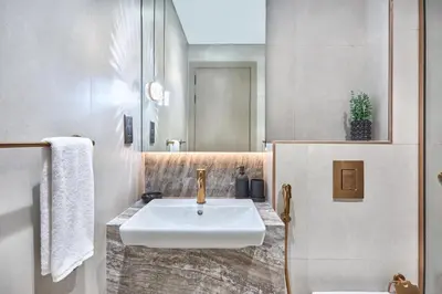 a bathroom with a white sink and a mirror at Lux High-Rise Studio 12th Floor Westwood Grande in Dubai