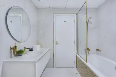 a white bathroom with two sinks and a mirror at Classy 2BR Apt in Shams1 Panoramic view in JBR in Dubai
