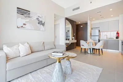 a living room with a couch and a table at Sky-High Downtown 1BR Steps from Burj Khalifa in Dubai