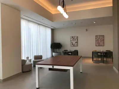 a living room with a table and a dining room at Sky-High Downtown 1BR Steps from Burj Khalifa in Dubai