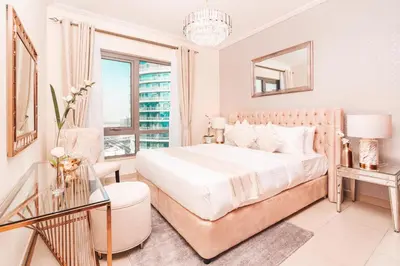 a white bedroom with a bed and a glass table at Elite Royal Apartment - Sky Series - Luxurious in Dubai