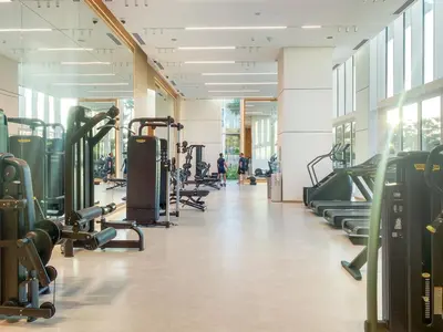 a gym with rows of treadmills and machines at Relaxing 1BR in Dubai With Access to Pool, Gym & Parking in Dubai