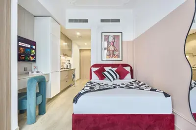 a bedroom with a bed with a red head board at Elegant Cozy Stu Luxury Stay 10 Min Dubai Mall in Dubai