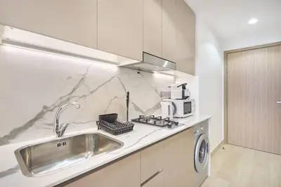 a kitchen with a sink and a microwave at Elegant Cozy Stu Luxury Stay 10 Min Dubai Mall in Dubai