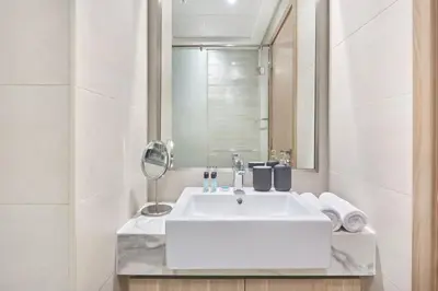 a bathroom with a white sink and a mirror at Elegant Cozy Stu Luxury Stay 10 Min Dubai Mall in Dubai