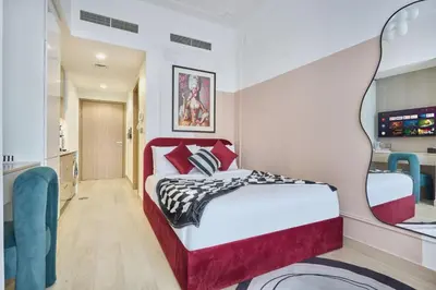 a bedroom with a bed with a red headboard and a mirror at Elegant Cozy Stu Luxury Stay 10 Min Dubai Mall in Dubai