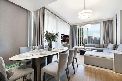 a living room with a table and chairs and a couch at Luxury 4BR Prime Downtown Stay in Dubai