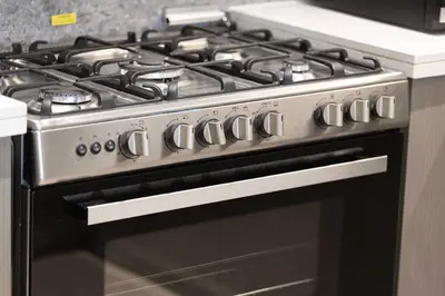 a black stove top oven in a kitchen at Luxury 4BR Prime Downtown Stay in Dubai