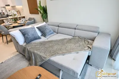a living room with a couch with a blanket on it at Stunning 1BR in JVC Binghatti Amber by Deleguest in Dubai