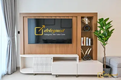 a living room with a television on a wall at Stunning 1BR in JVC Binghatti Amber by Deleguest in Dubai