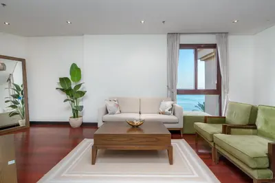 a living room with a couch and a coffee table at Burj & Sea View King 2 Bedroom Apartment In Anantara Resort in Dubai