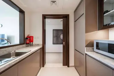 a kitchen with a sink and a microwave at Downtown Dubai Luxury 1 BR in BLVD Heights T1 in Dubai
