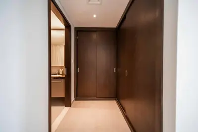 a hallway with wood paneled walls and a door at Downtown Dubai Luxury 1 BR in BLVD Heights T1 in Dubai