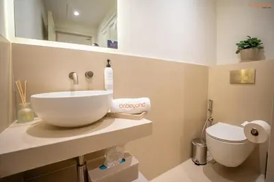 a bathroom with a sink and a toilet at Bnbeyond's Luxury Vibe & Burj View in Dubai