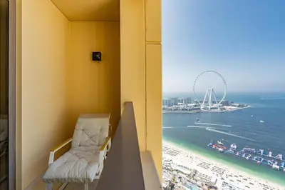 a balcony with a view of the ocean and a beach at King 2 Bedroom Jumeirah Beach & Dubai Eye Views in Dubai