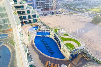 an overhead view of a building with a swimming pool at Bloomfields Charming Stu in Samana View in Dubai