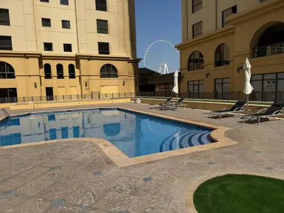 a swimming pool in the middle of a building at Large 5-BR JBR Apartment, Perfect for Families, Easy Beach Access in Dubai