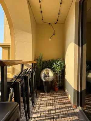 a restaurant with chairs and a table and plants at Large 5-BR JBR Apartment, Perfect for Families, Easy Beach Access in Dubai