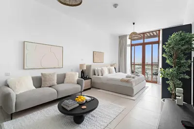 a living room with a couch and a table at Silkhaus Seaside Studio in Palm Views West Tower in Dubai