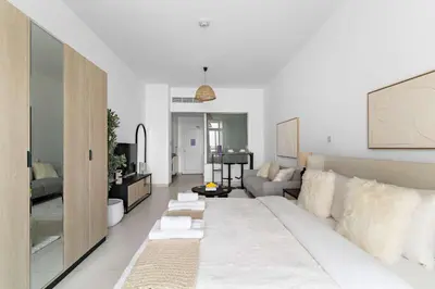 a living room with a couch and a table at Silkhaus Seaside Studio in Palm Views West Tower in Dubai