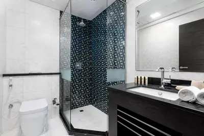 a bathroom with a shower and a toilet and a sink at Maison Privee - Sleek Stay in Dubai Marina Famous Twisting Tower in Dubai