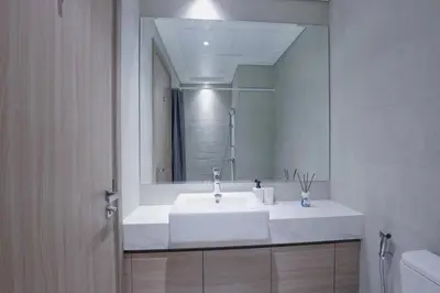 a bathroom with a white sink and a mirror at Azizi Riviera 42 - Meydan by Golden Casa in Dubai