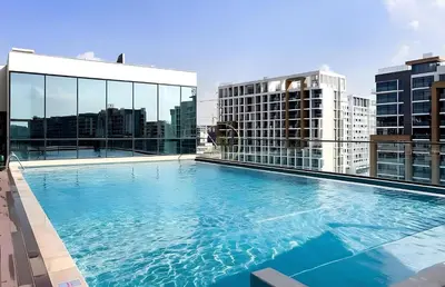 a large swimming pool on top of a building at Sobha Hartland Waves-912 in Dubai