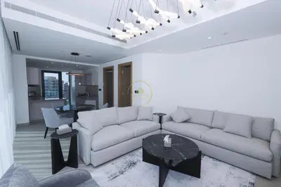a living room with a couch and a table at Sobha Hartland Waves-912 in Dubai