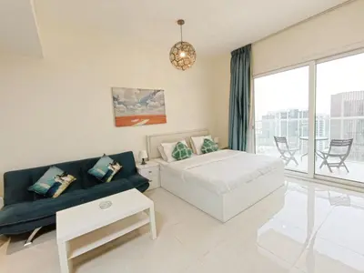 a living room with a bed and a couch at SUPERIOR STAY HOLIDAY HOMES - Sleek & Modern Studio in Business Bay in Dubai