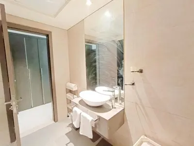 a bathroom with a sink and a mirror and a shower at SUPERIOR STAY HOLIDAY HOMES - Sleek & Modern Studio in Business Bay in Dubai