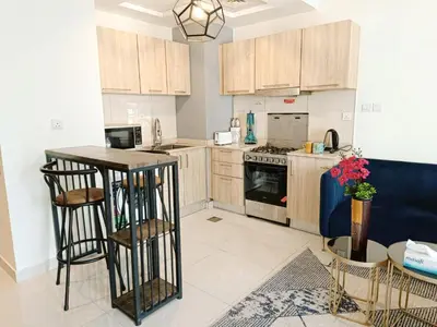 a kitchen with wooden cabinets and a counter top at SUPERIOR STAY HOLIDAY HOMES - Sleek & Modern Studio in Business Bay in Dubai