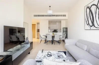 a living room with a couch and a table at Canal View, Partial Burj Khalifa View in Dubai