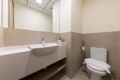 a bathroom with a sink and a toilet at Canal View, Partial Burj Khalifa View in Dubai