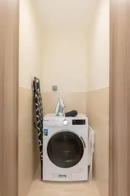 a washer and dryer in a small room at Partial Canal View, Business Bay in Dubai