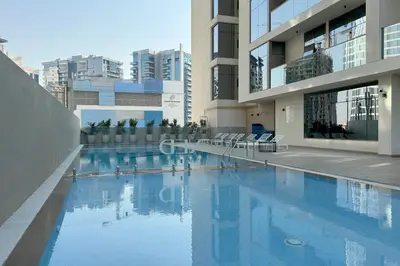 a swimming pool in the middle of a building at Partial Canal View, Business Bay in Dubai